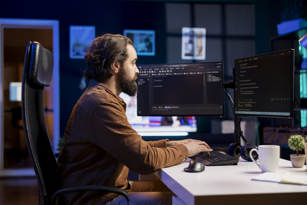 Computer engineer typing on keyboard, writing code to build firewalls